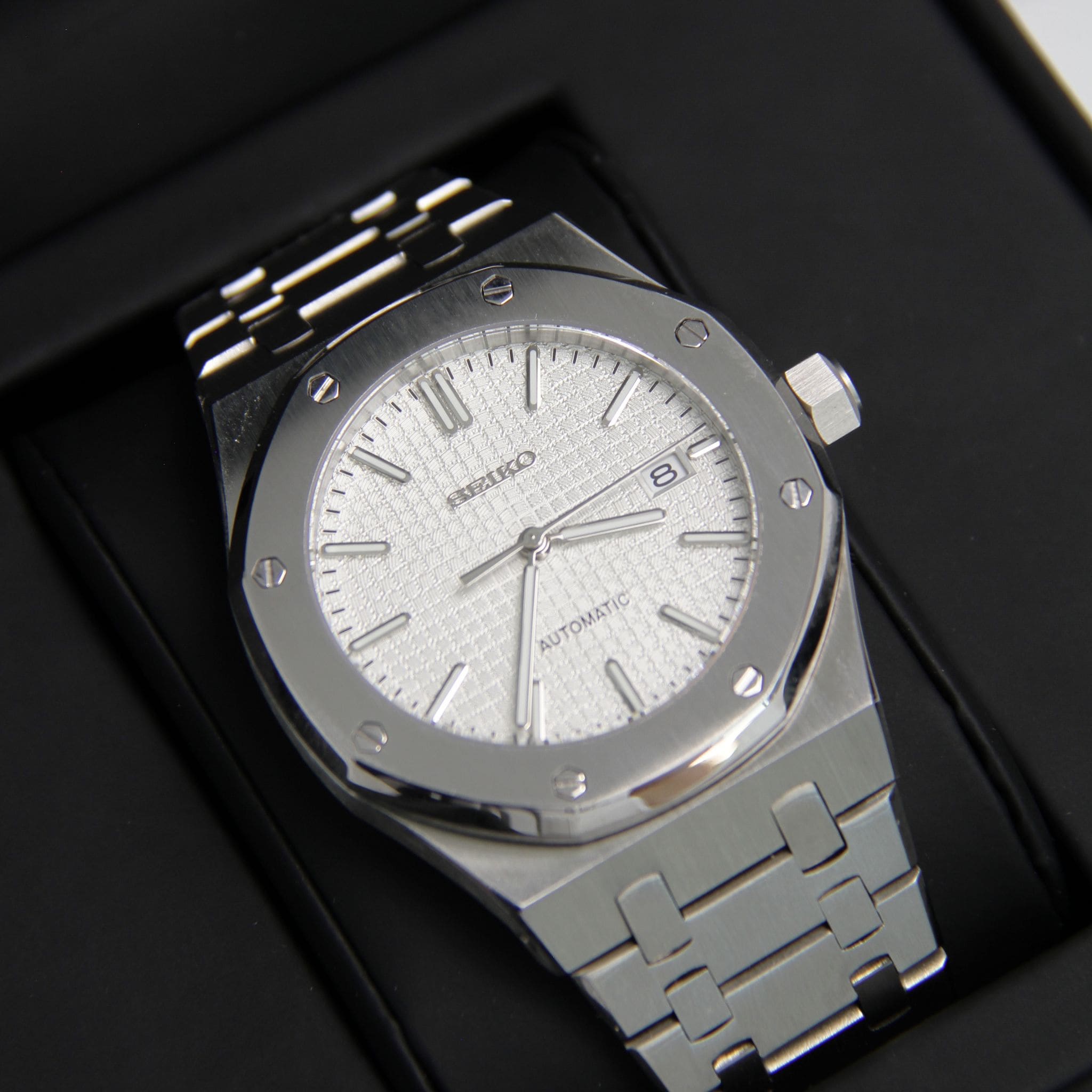 Montre Seiko mod royal oak blanc vu de face sur coussin